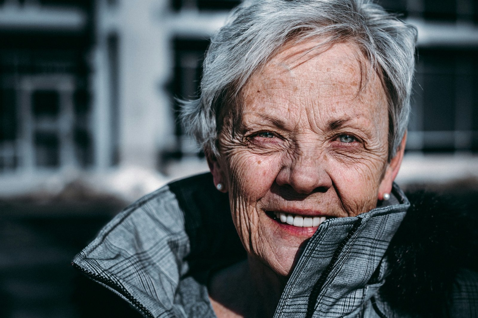 Older woman with a rounded face smiling warmly
