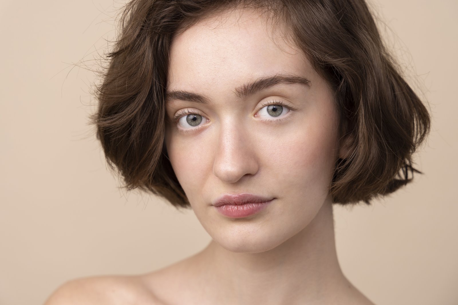 Woman with a small pointed chin and a calm expression