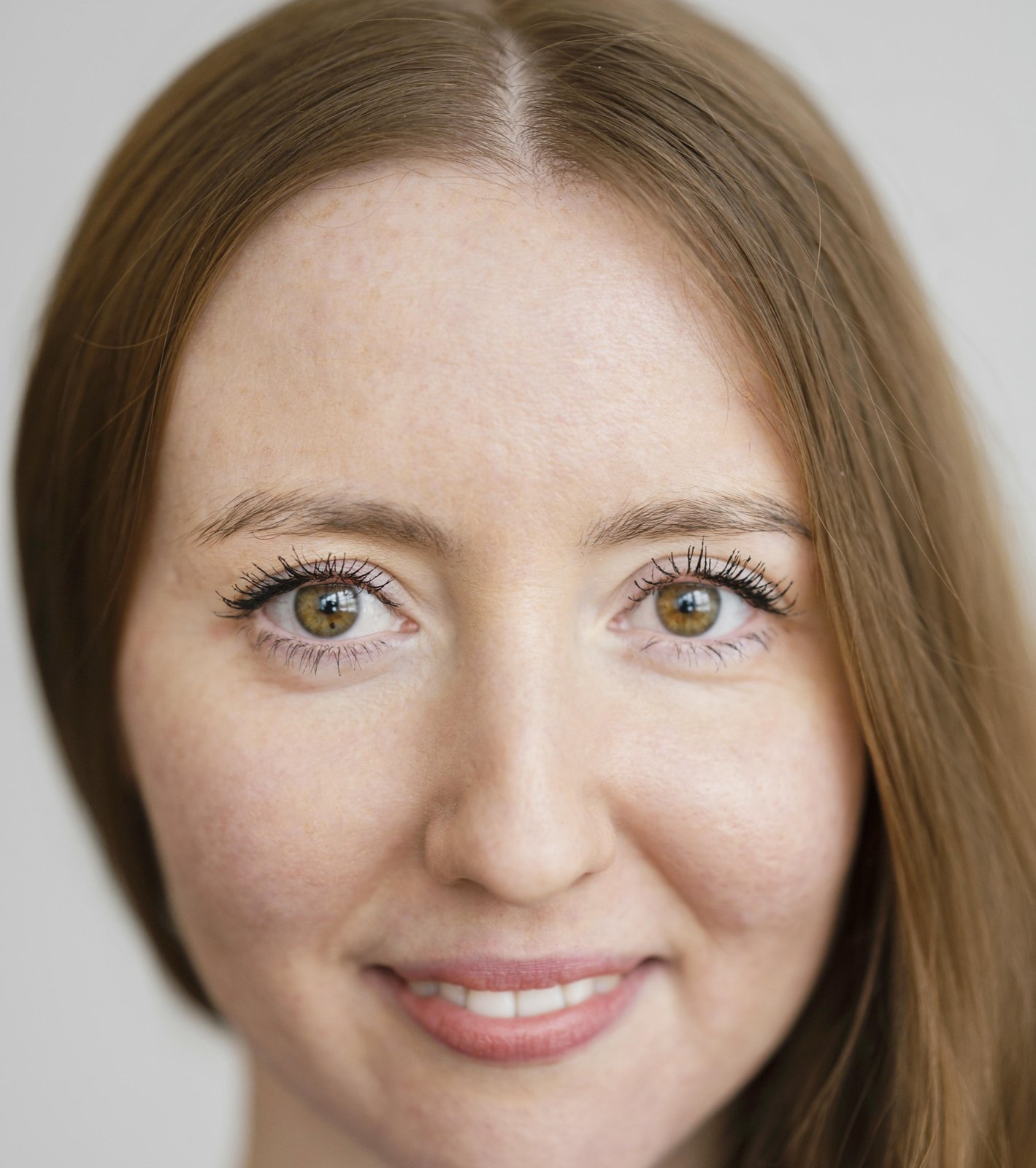 Woman with a calm, gentle expression and a soft smile