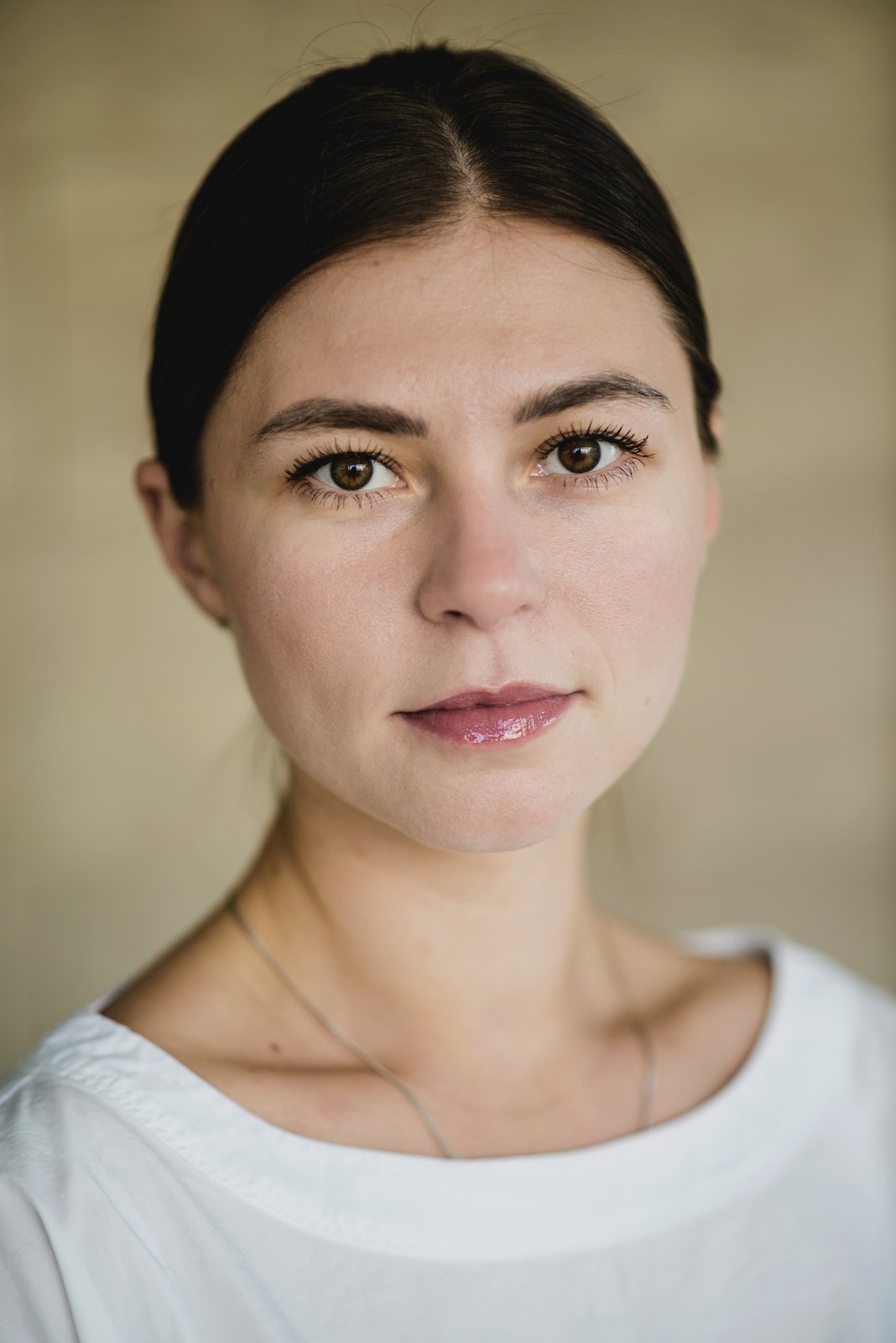 Woman with a calm, steady gaze and a relaxed expression