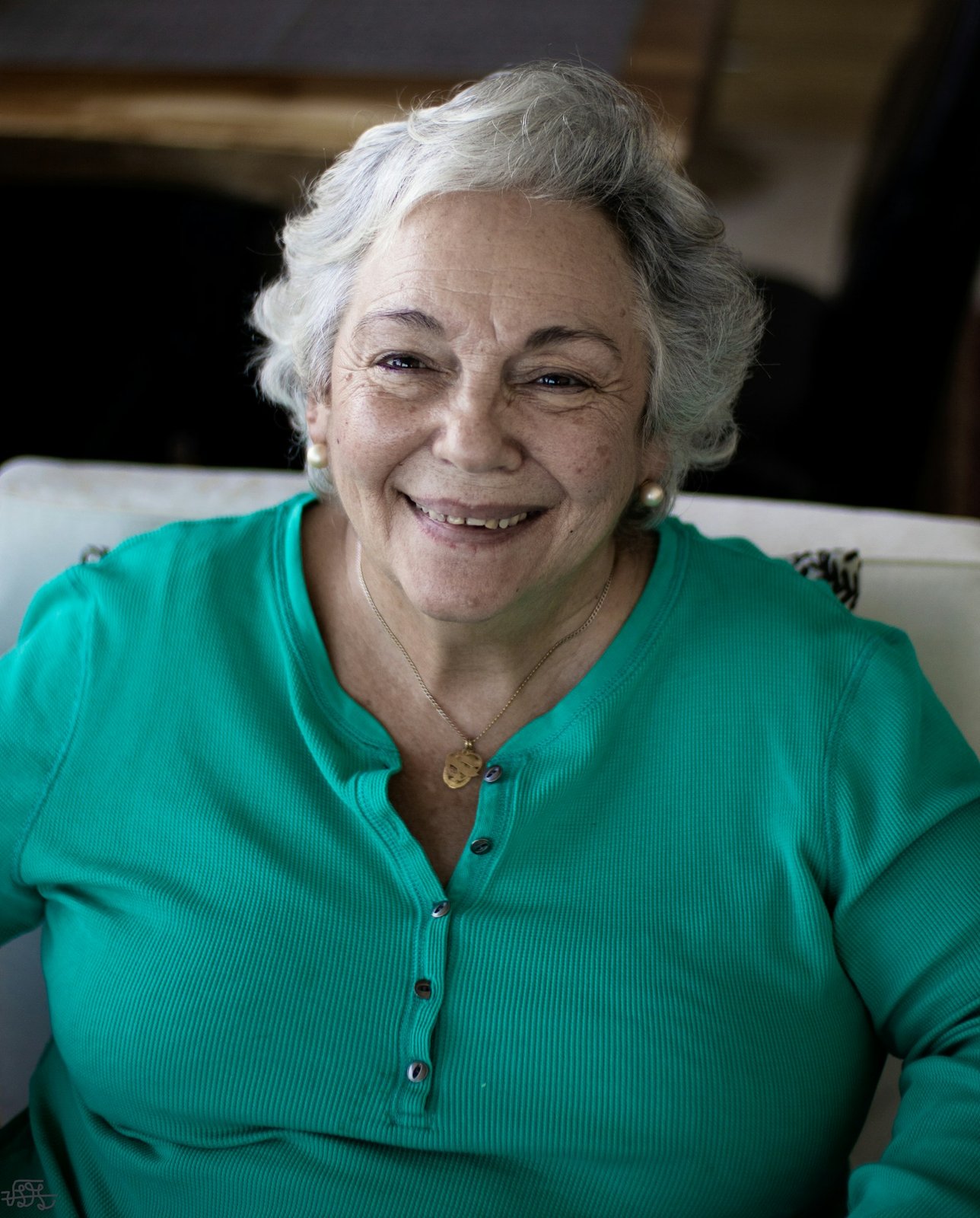 Smiling older woman with a round, full face and a warm expression