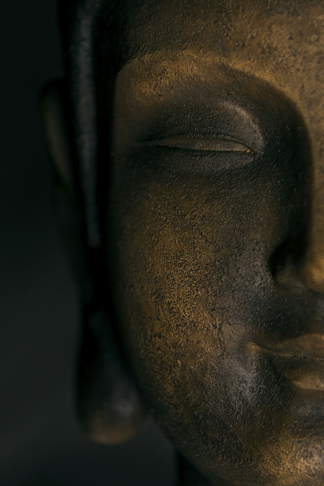 Bronze Buddha statue with a long, full earlobe