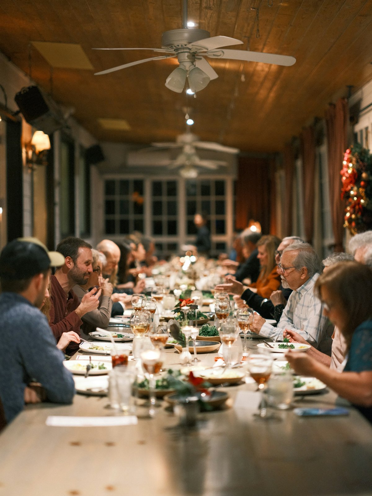 A multi-generation family sharing dinner at a long table