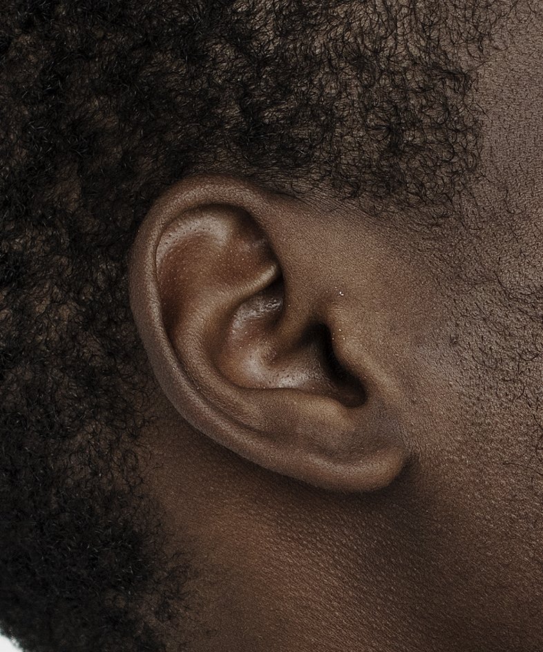 Close-up of an ear whose rounded rim wraps inward over a round earlobe