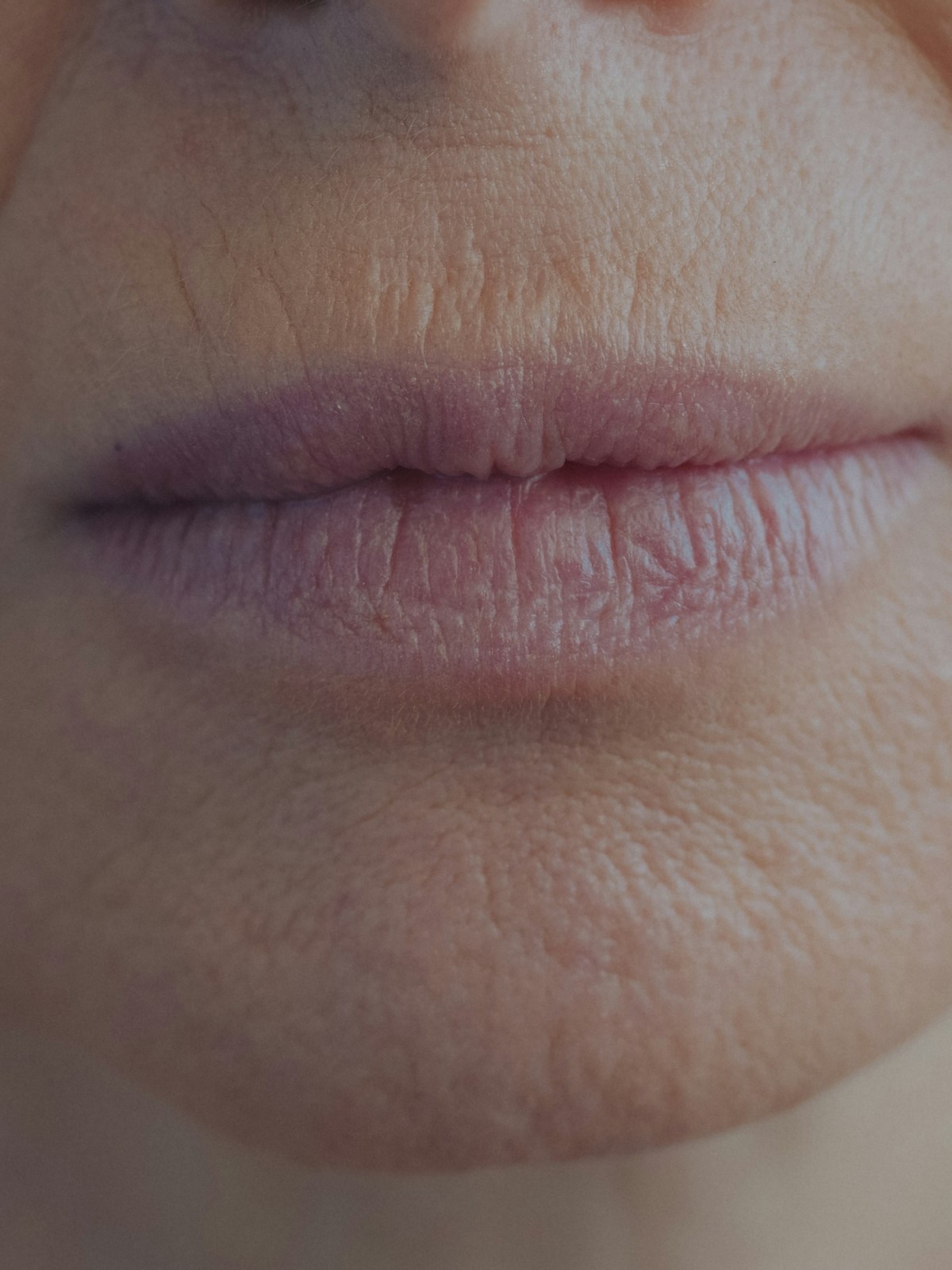 Close-up of closed lips showing fine natural lip lines