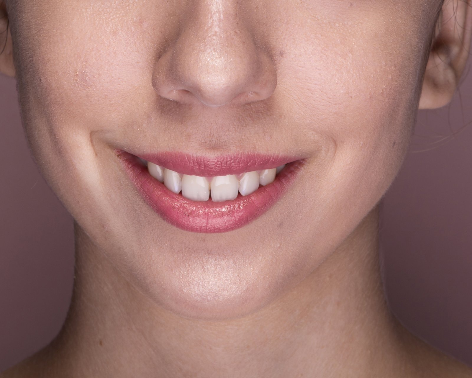Lower face with a clear philtrum, upturned mouth corners and a rounded chin