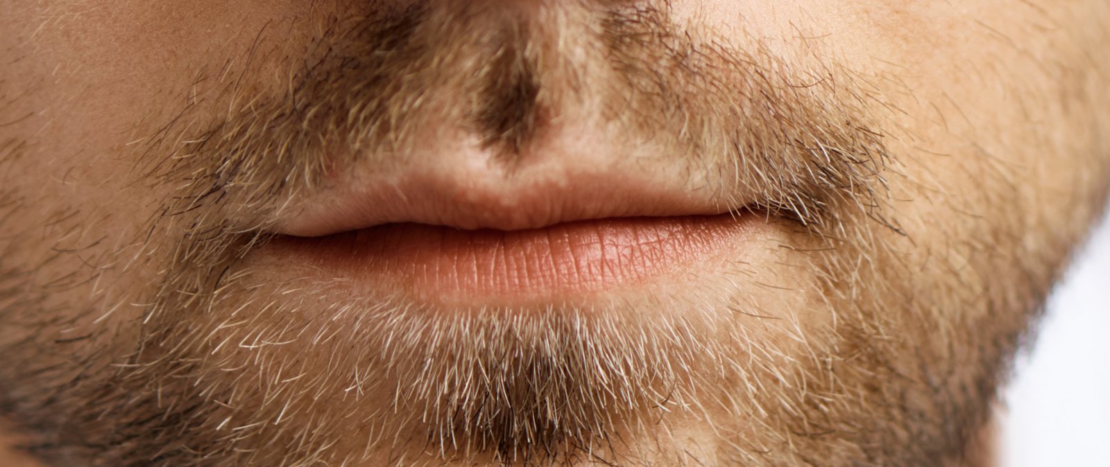 Close-up of thin lips pressed together in a line
