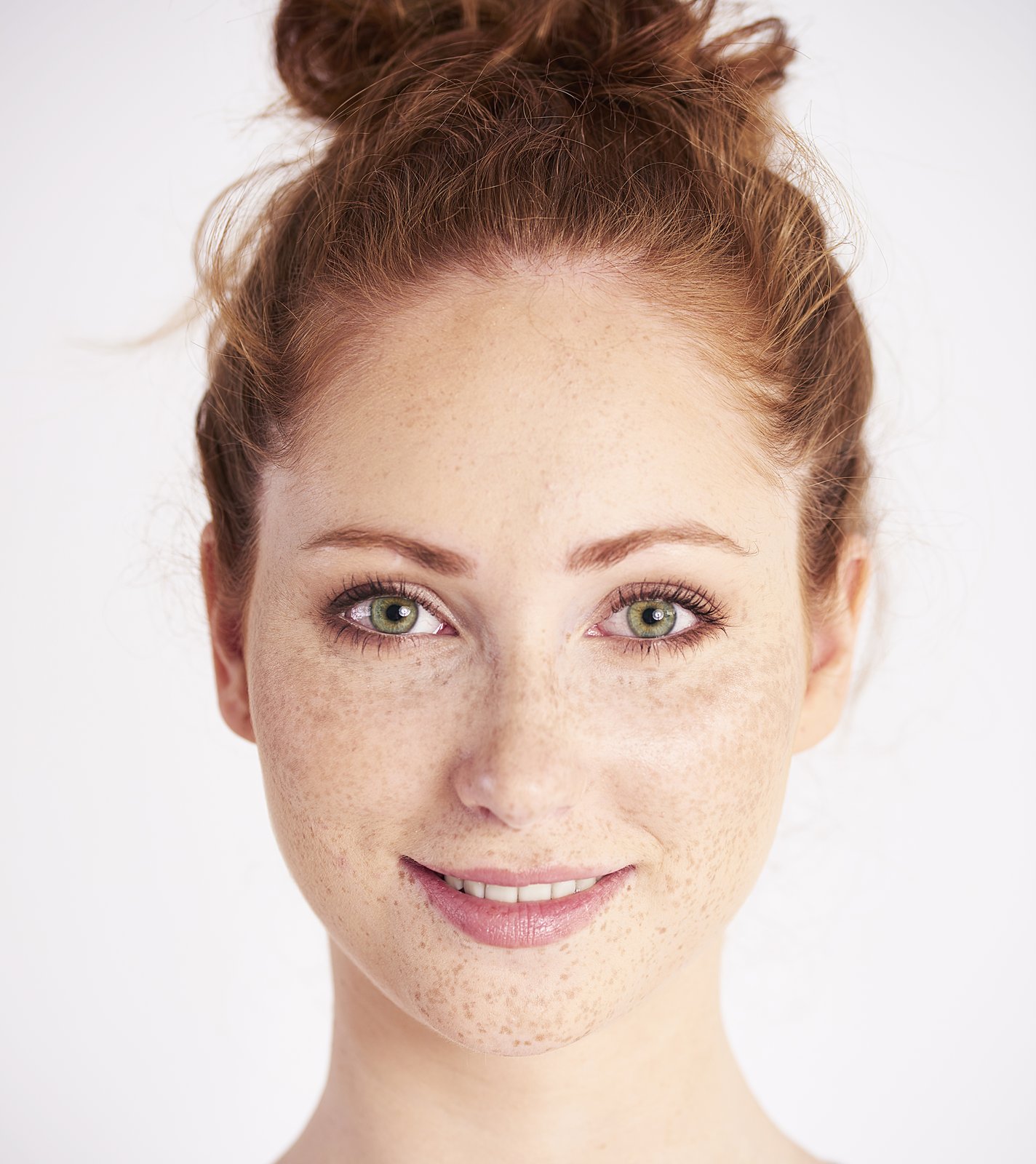 Woman with soft, symmetrical features and a friendly smile