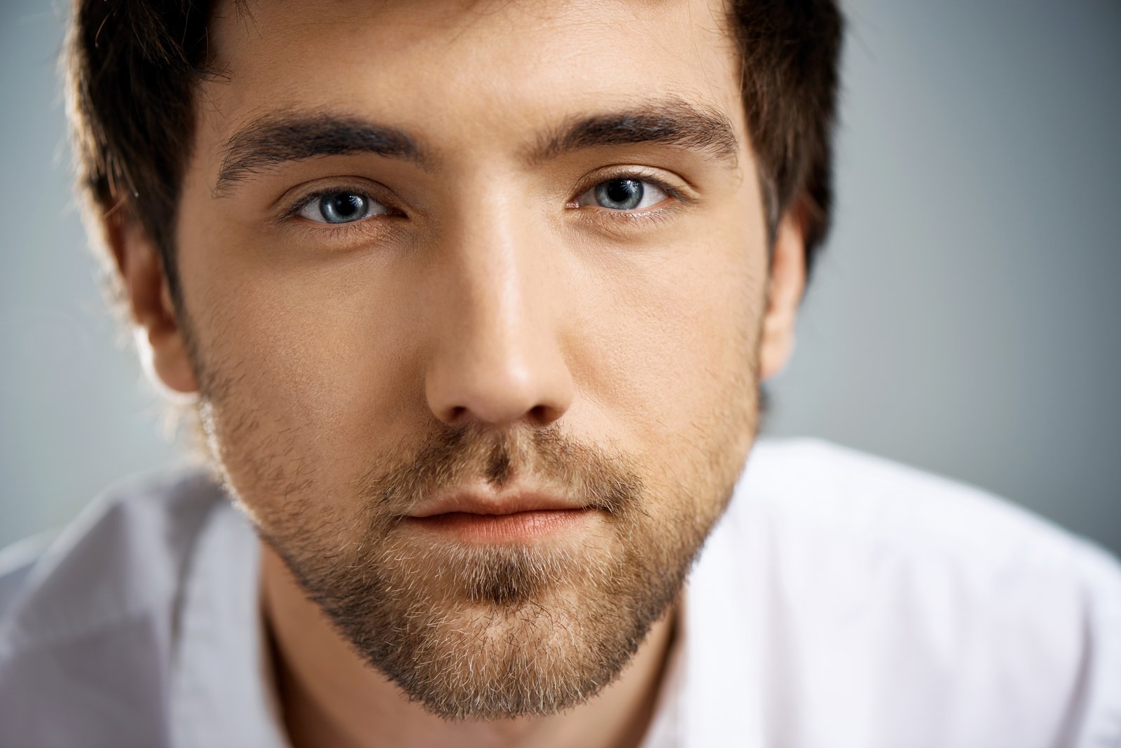Man with strong brows and a bright, direct gaze