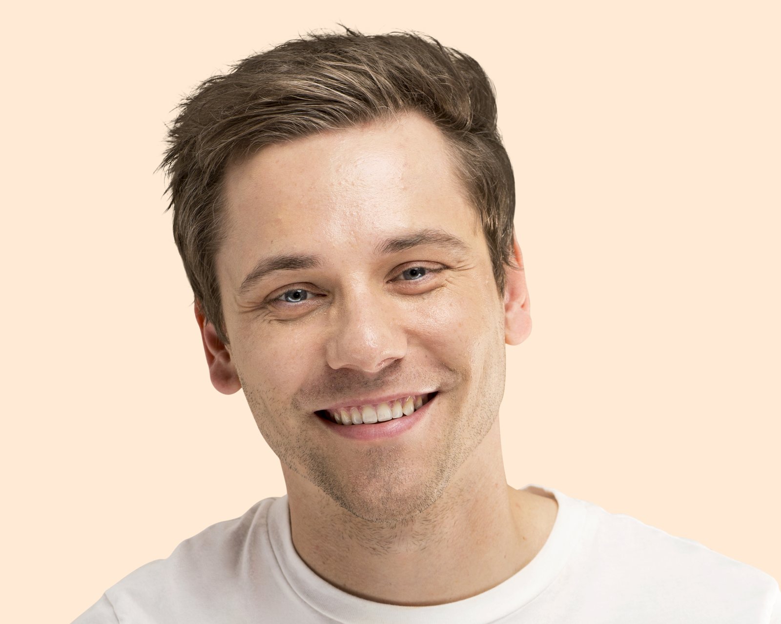Smiling man with relaxed brows and warm eyes