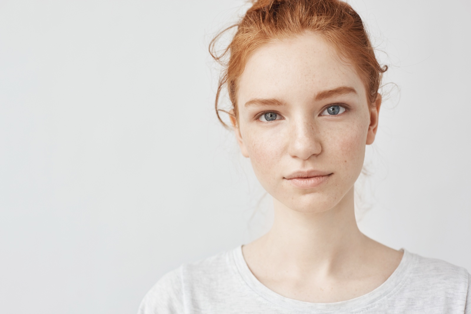 Young woman with a clear, bright complexion and red hair