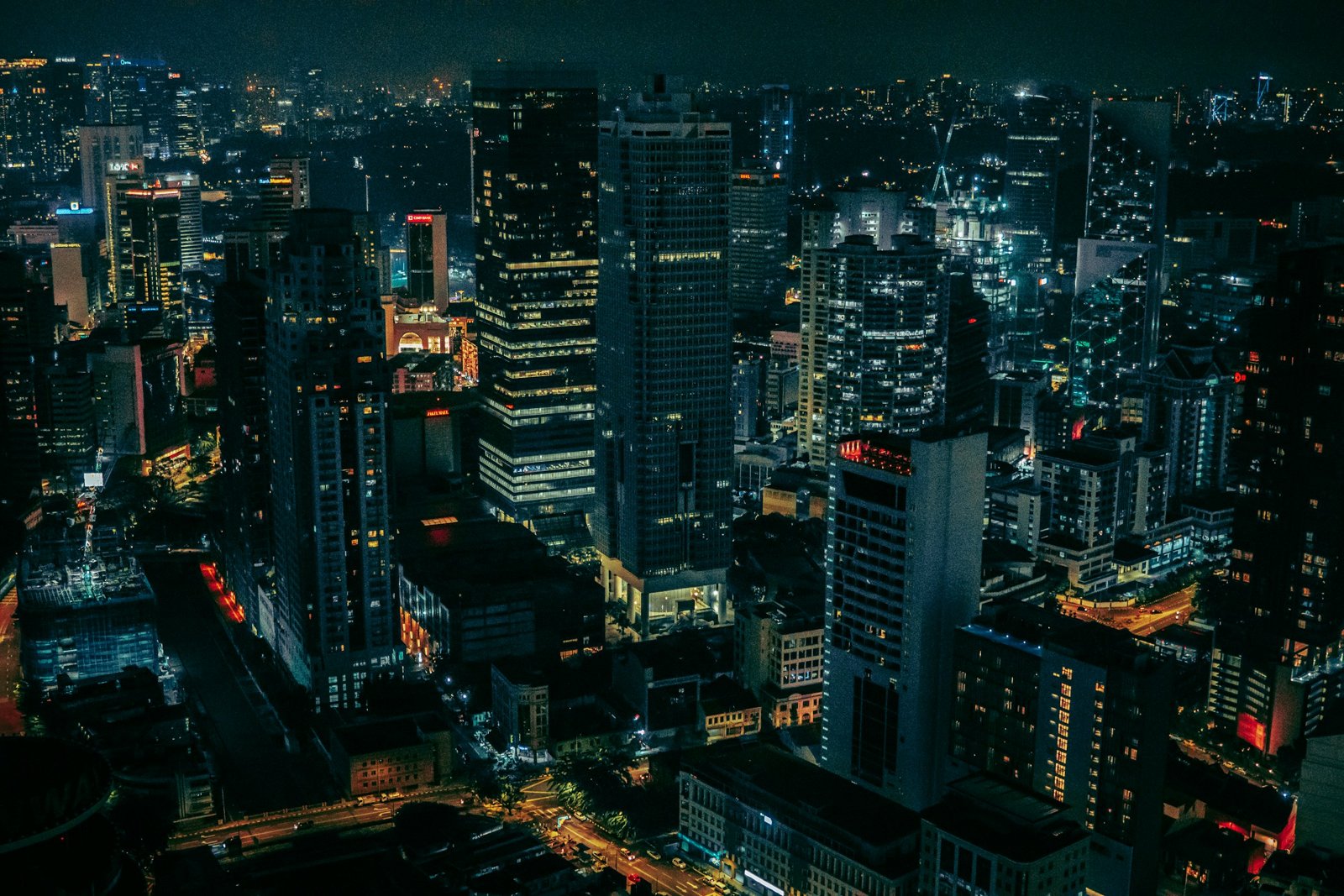 Aerial view of a city at night with lit streets