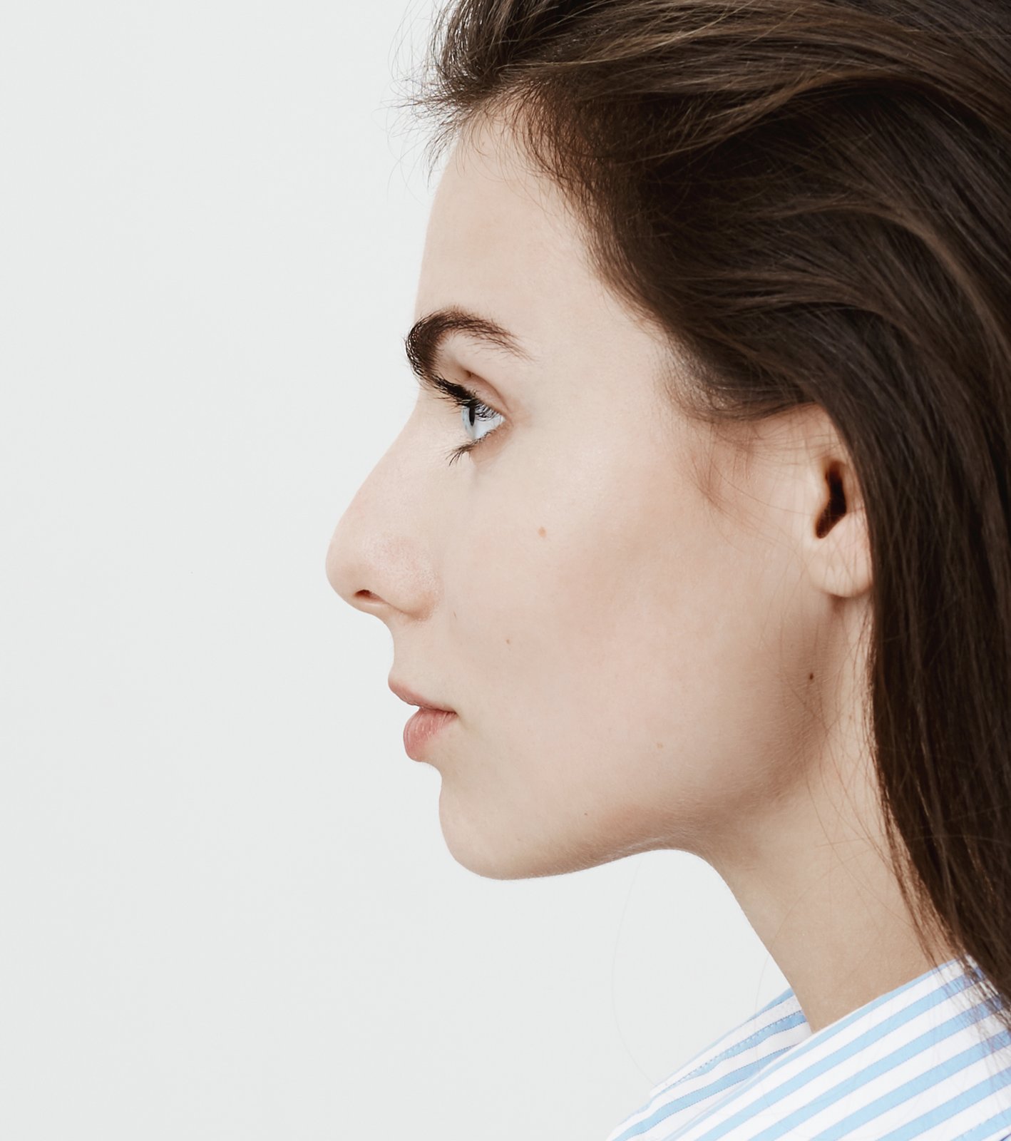 Side profile of a young woman showing her nose, cheek and chin