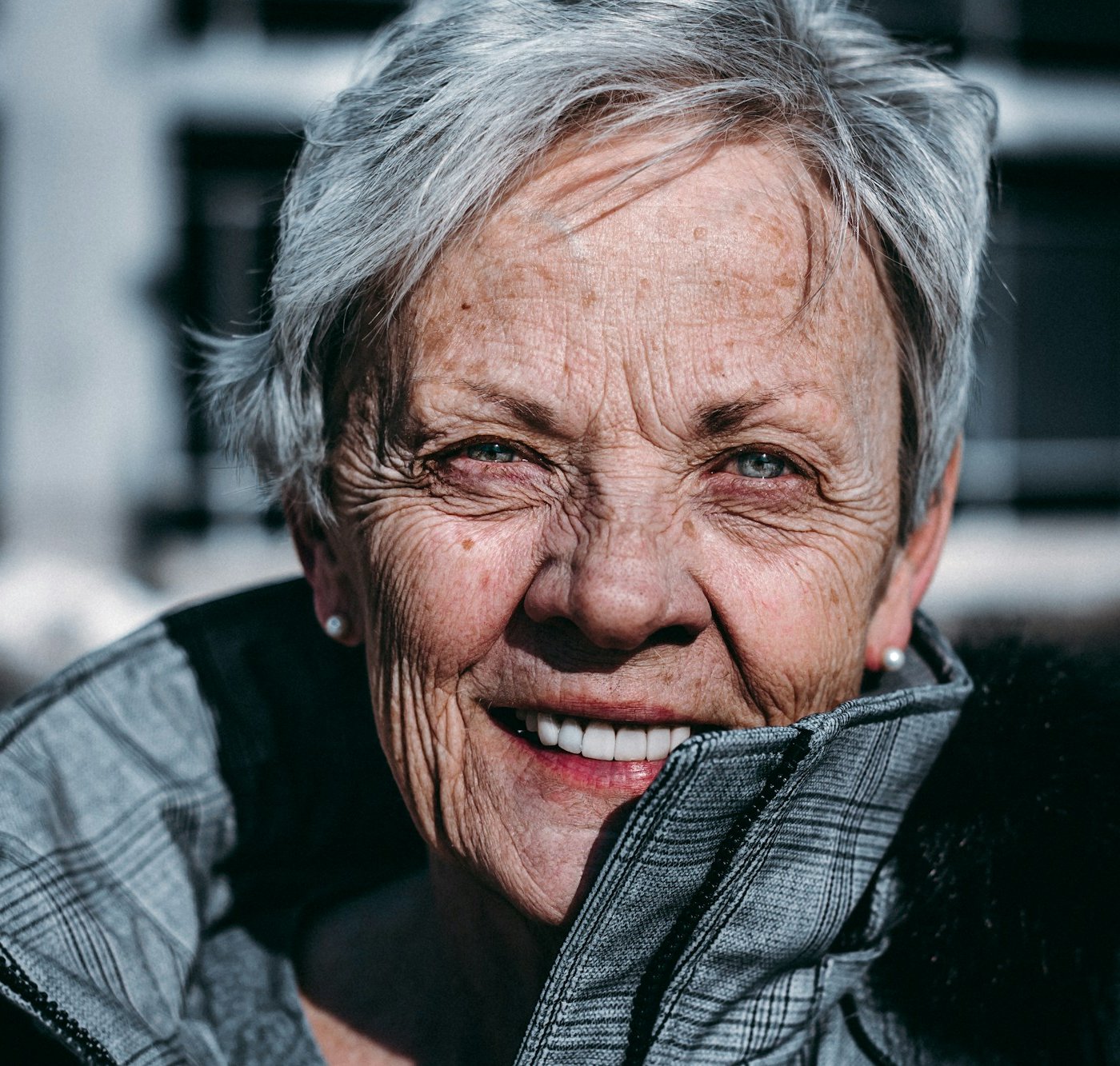 Smiling older woman with fine, even wrinkles on her cheeks