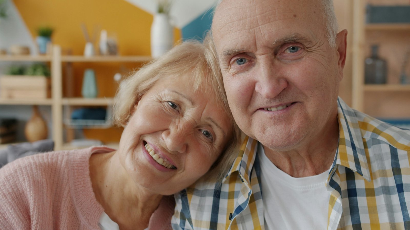 Smiling elderly couple leaning their heads together