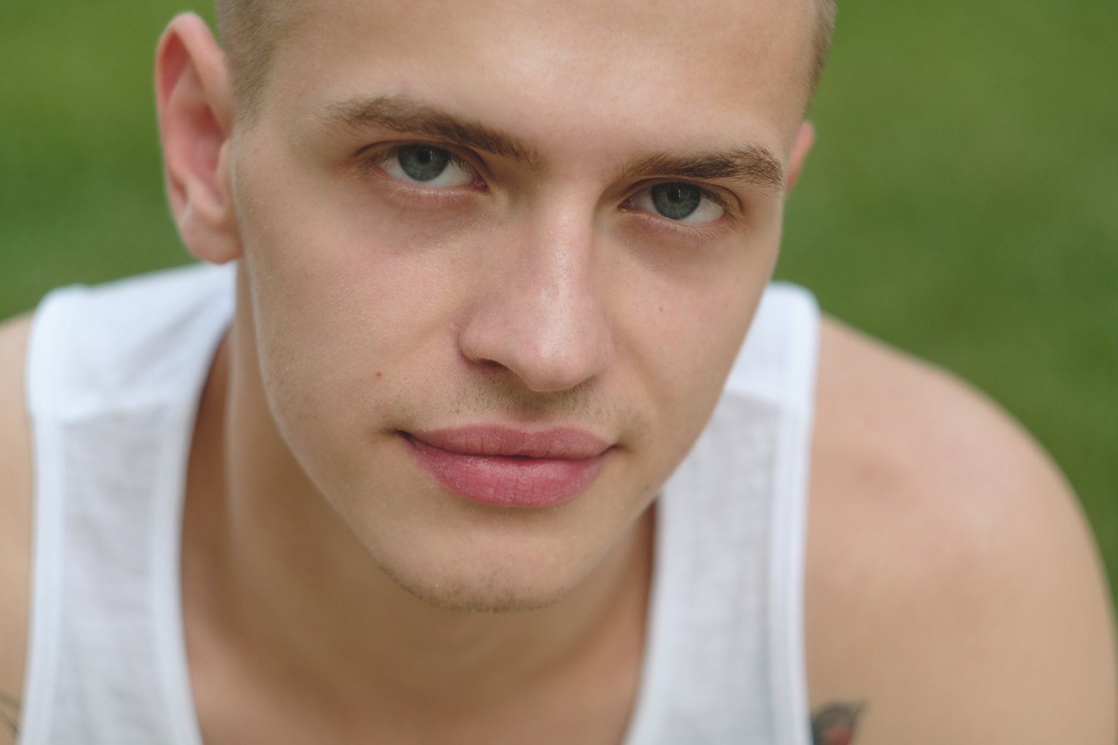 Fair-skinned young man with a square face looking at the camera