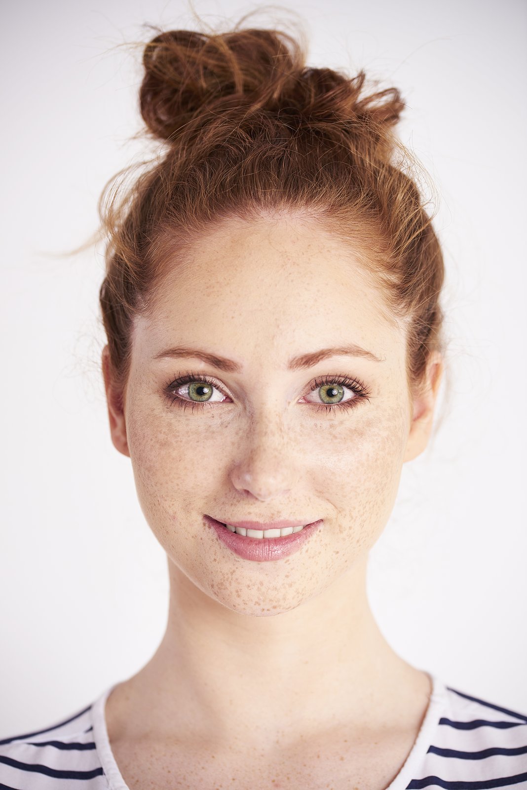 Smiling woman with hair up showing a smooth, rounded forehead
