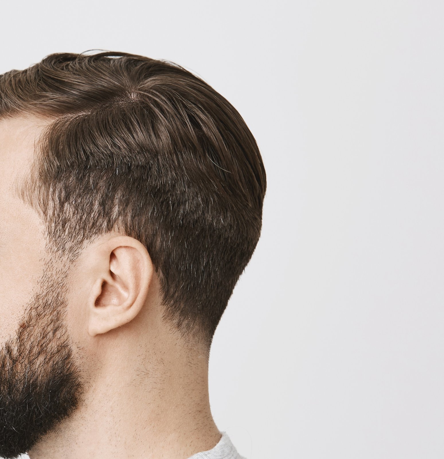 Side view of a hairline that flows into the sideburns and beard