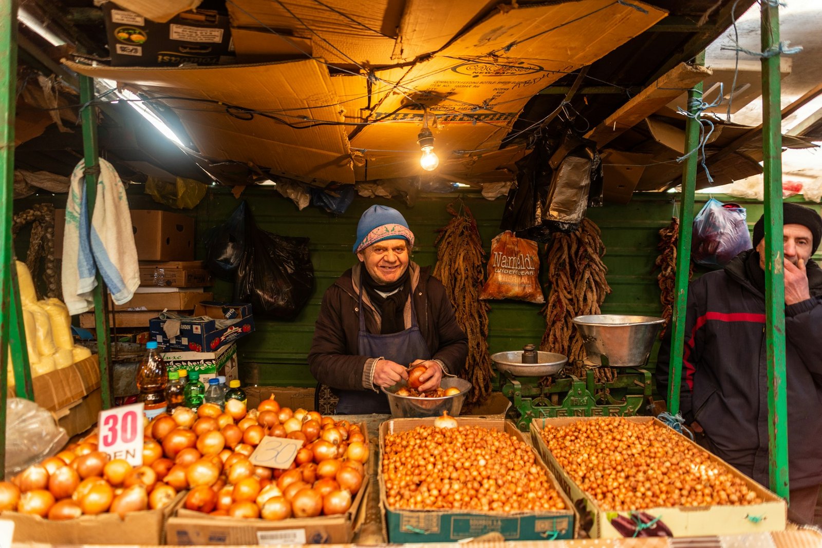 Vegetable stall at a market with its vendor