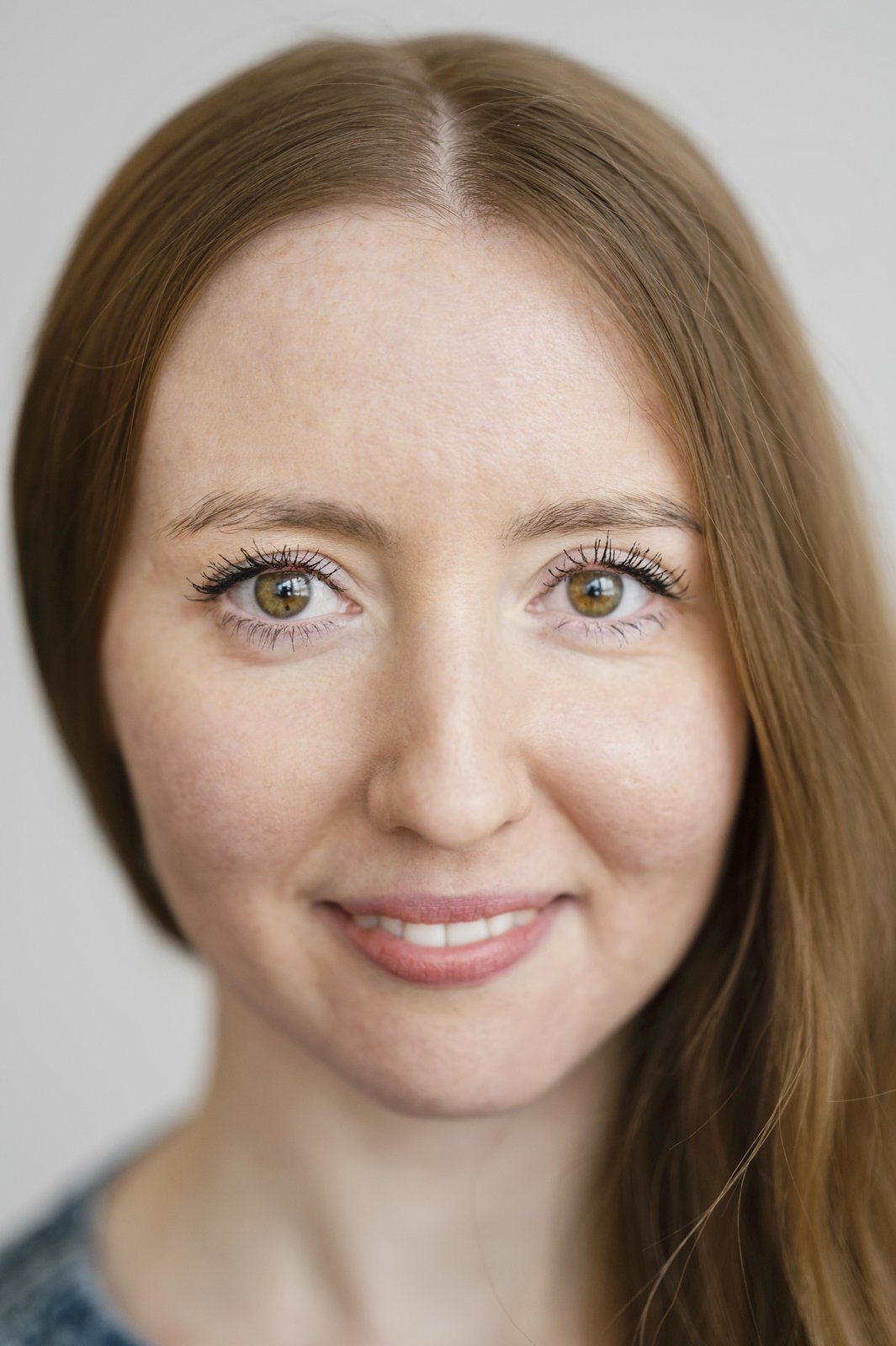 Woman with a warm, gentle smile and clear eyes