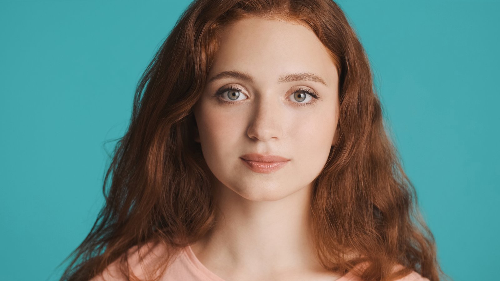 Woman with softly sloping eyebrows and a gentle, approachable expression