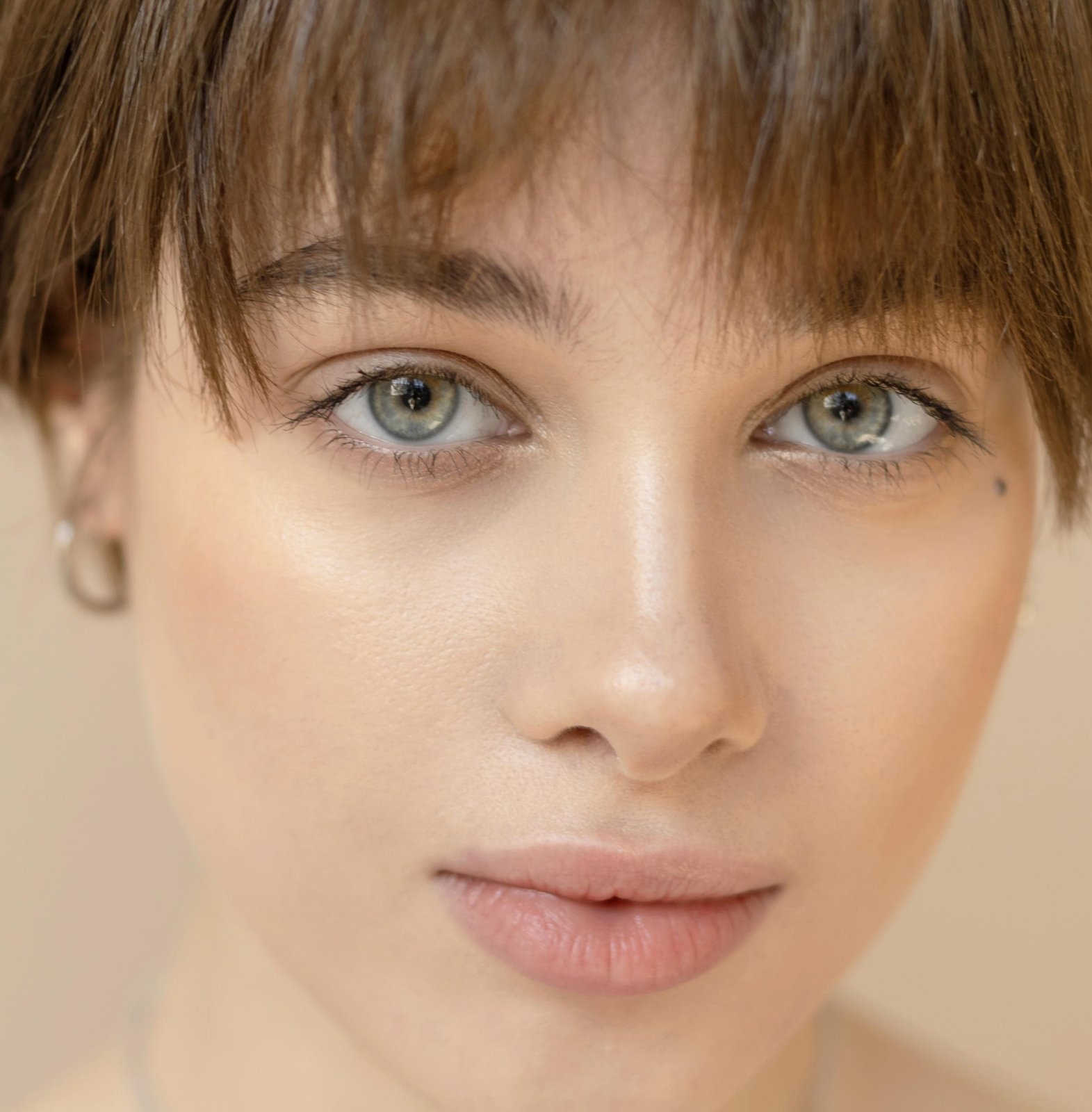 Young woman with bright, clear eyes looking at the camera