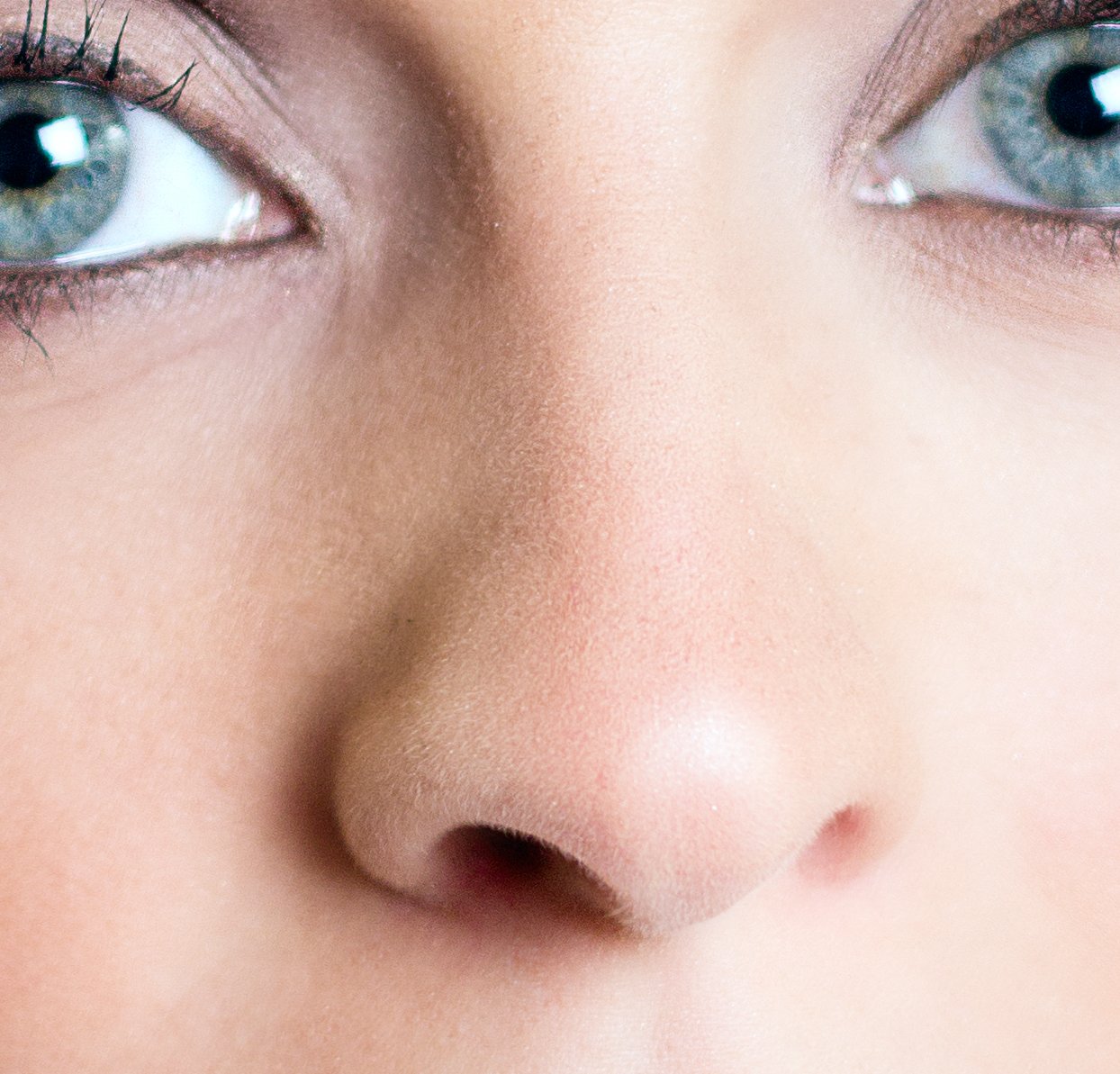 Close-up of a straight nose with a smooth bridge and full nasal wings