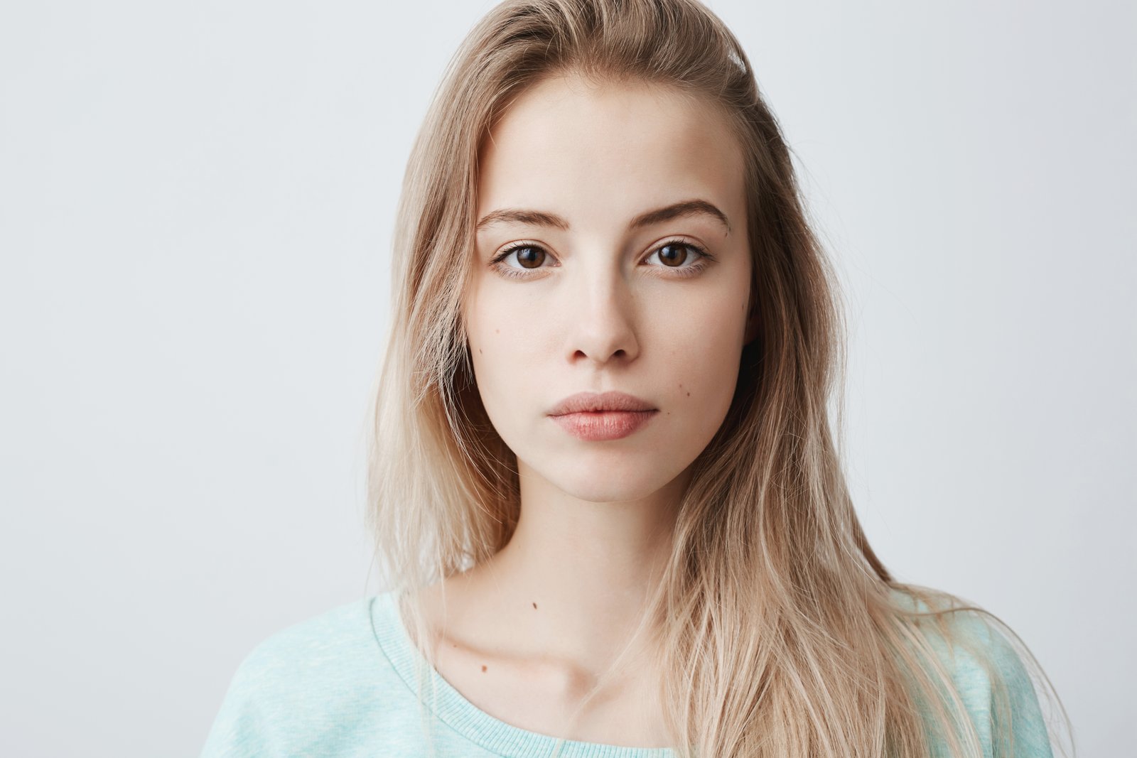A calm young woman in soft natural light