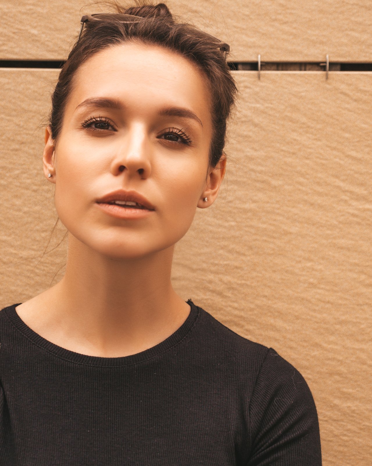 Young woman with a warm, glowing complexion looking at the camera