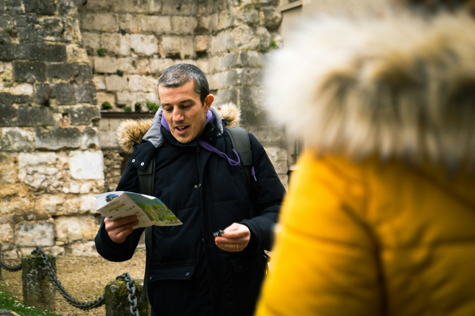 Man with a map asking a passer-by for directions