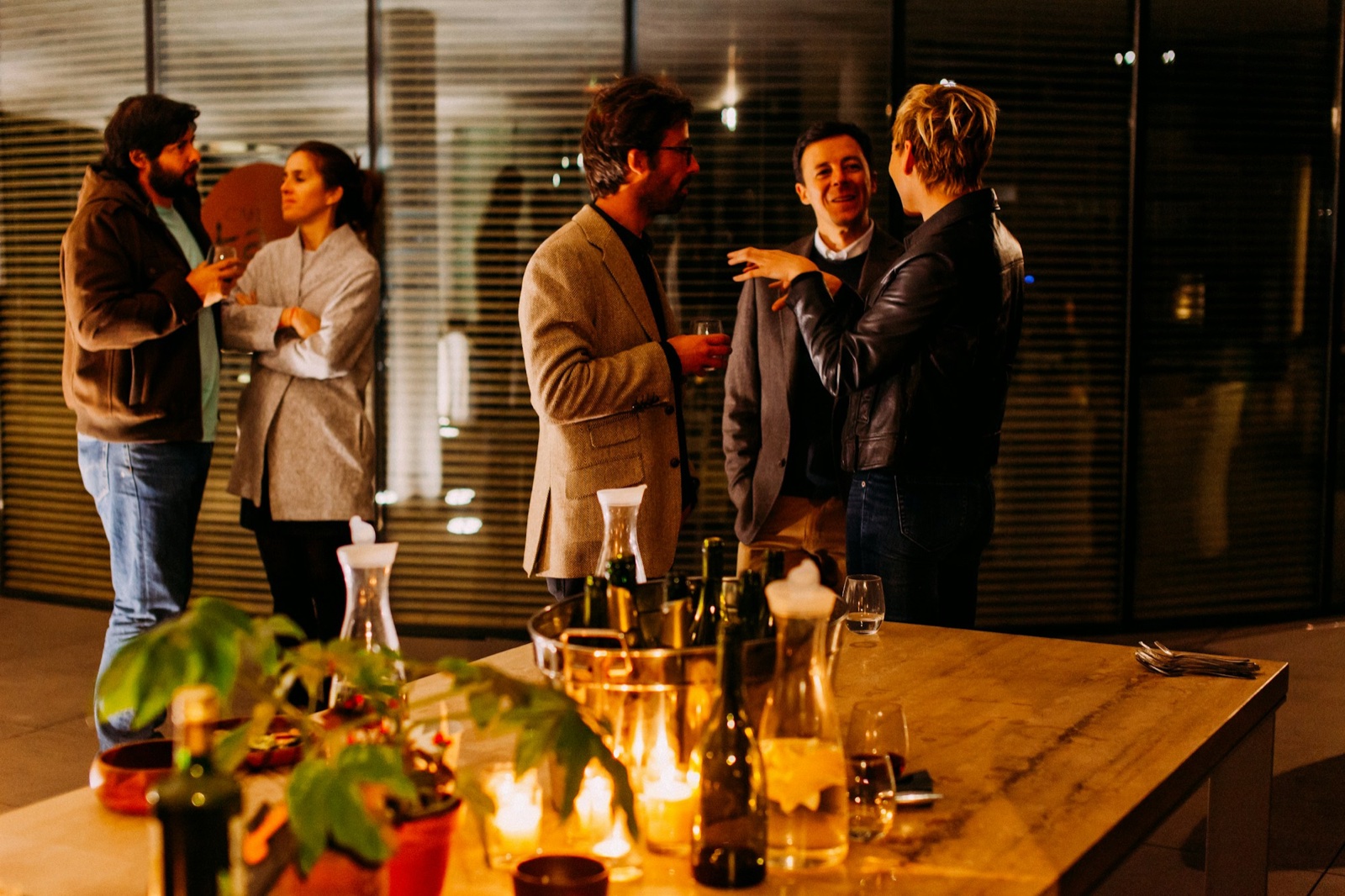 Small group of people chatting at an evening social event