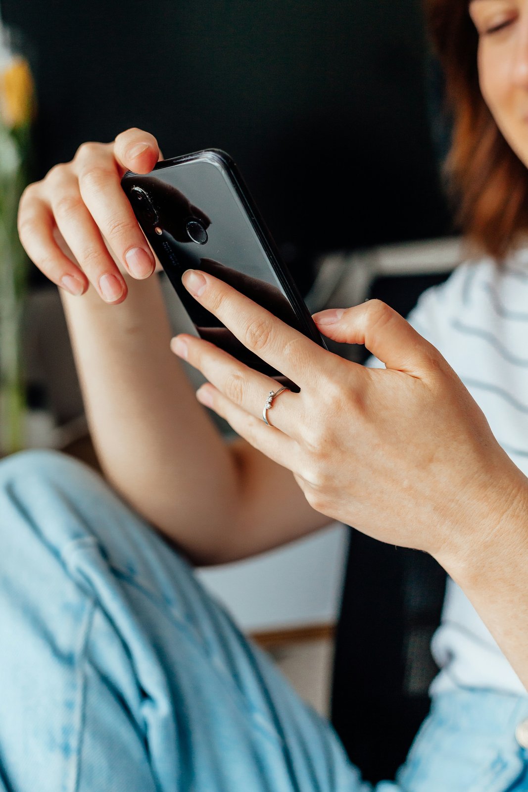 Person scrolling a social media feed on a phone
